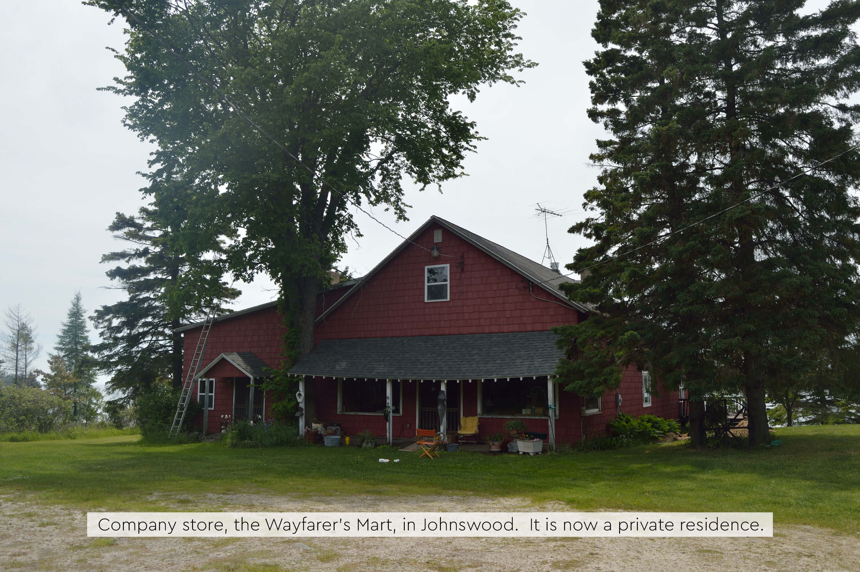 The Wayfarer's Mart, a red wooden building surrounded by trees.