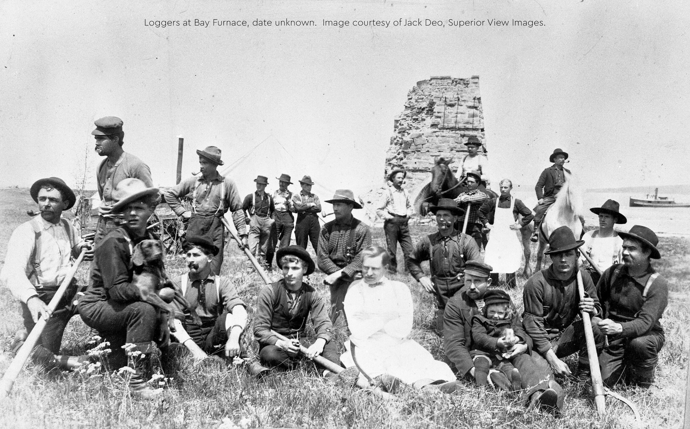 Group of loggers posing near Bay Furnace ruins.