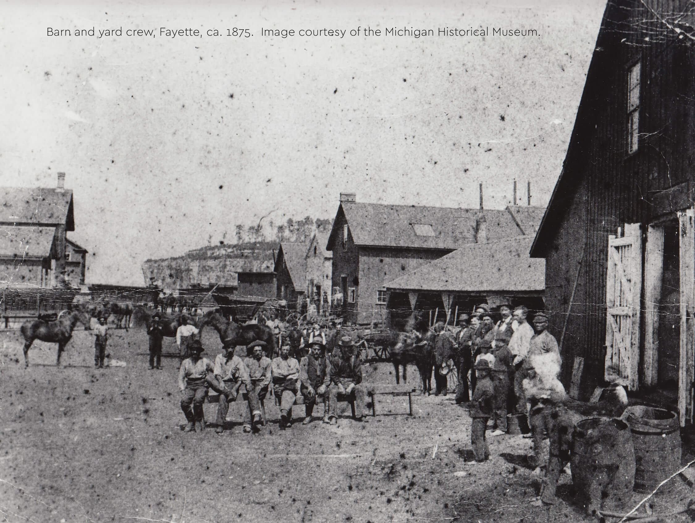 Historic photo of barn workers, horses, and buildings in Fayette, ca. 1875.
