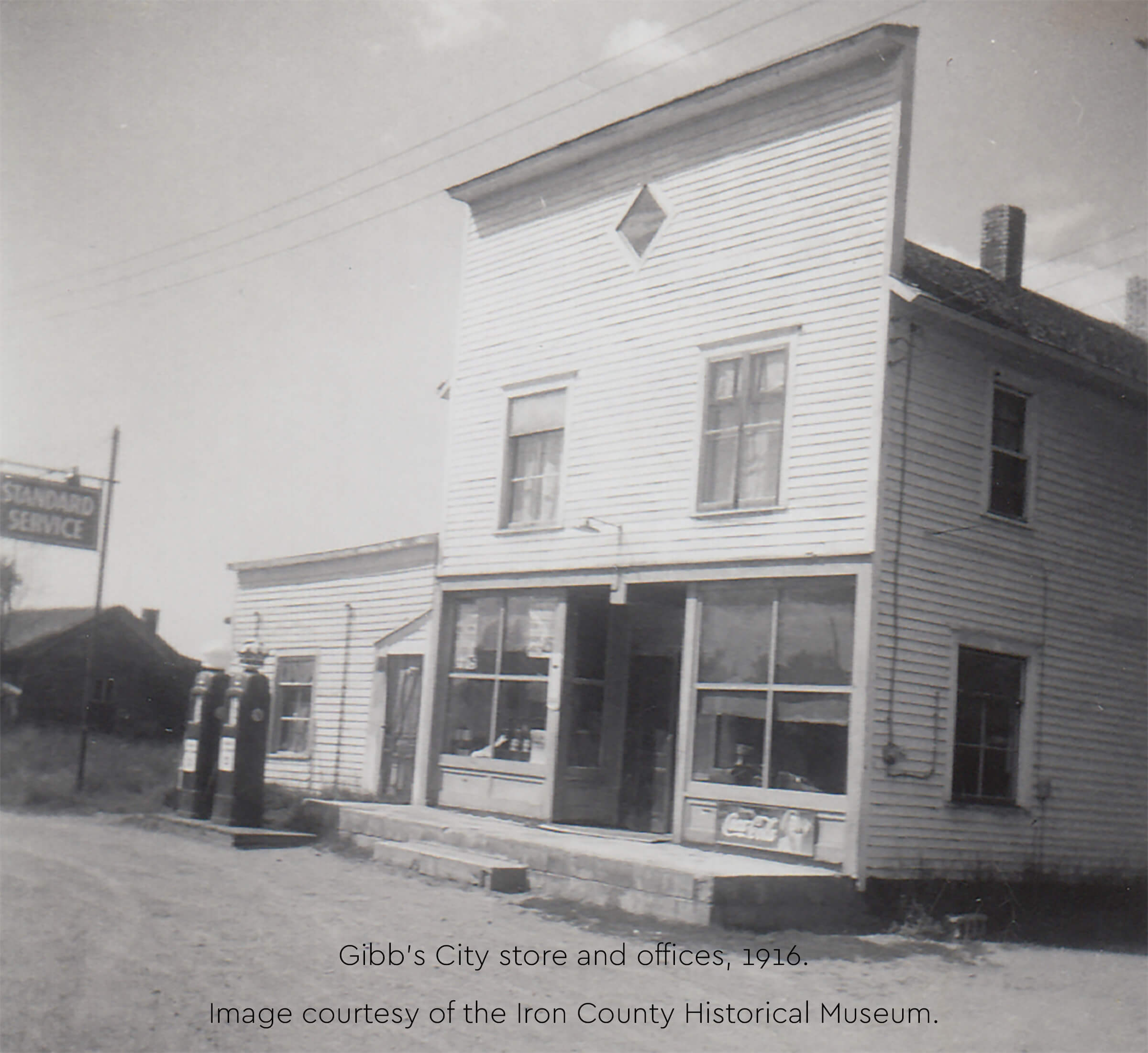 A historic photograph of a two-story wooden store.