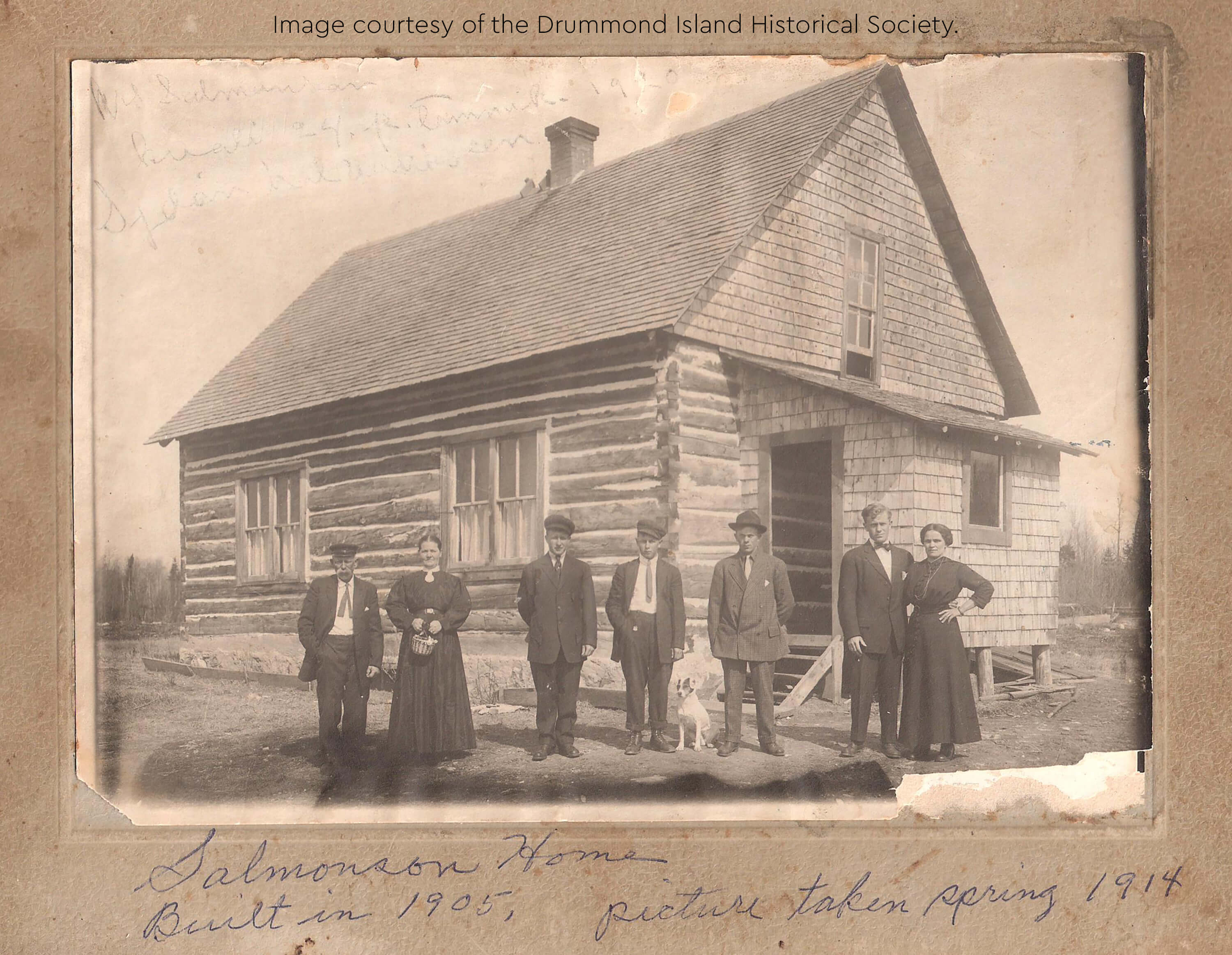 Historic image of the Salmonson family in front of their log house.