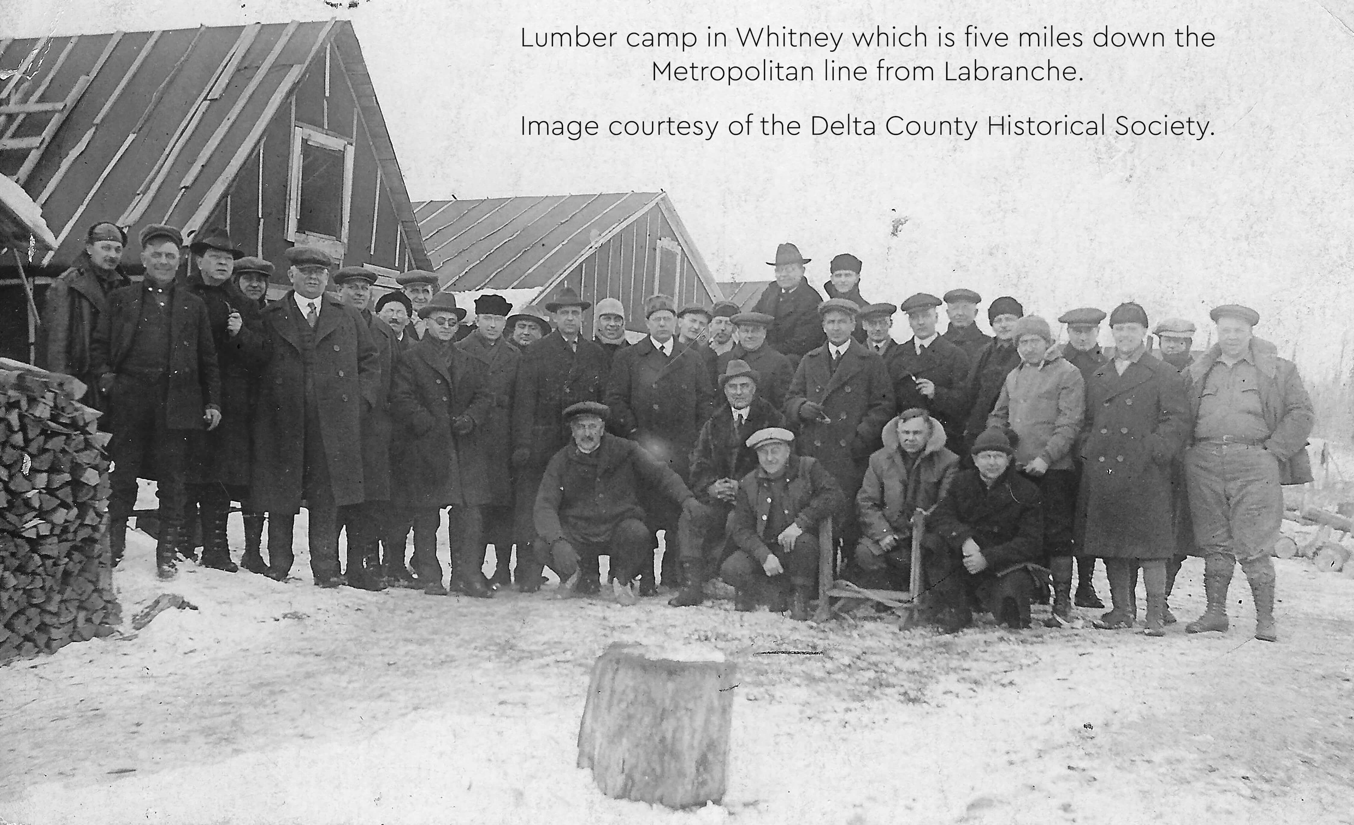 Group photo of workers at a lumber camp in Whitney, near Labranche.