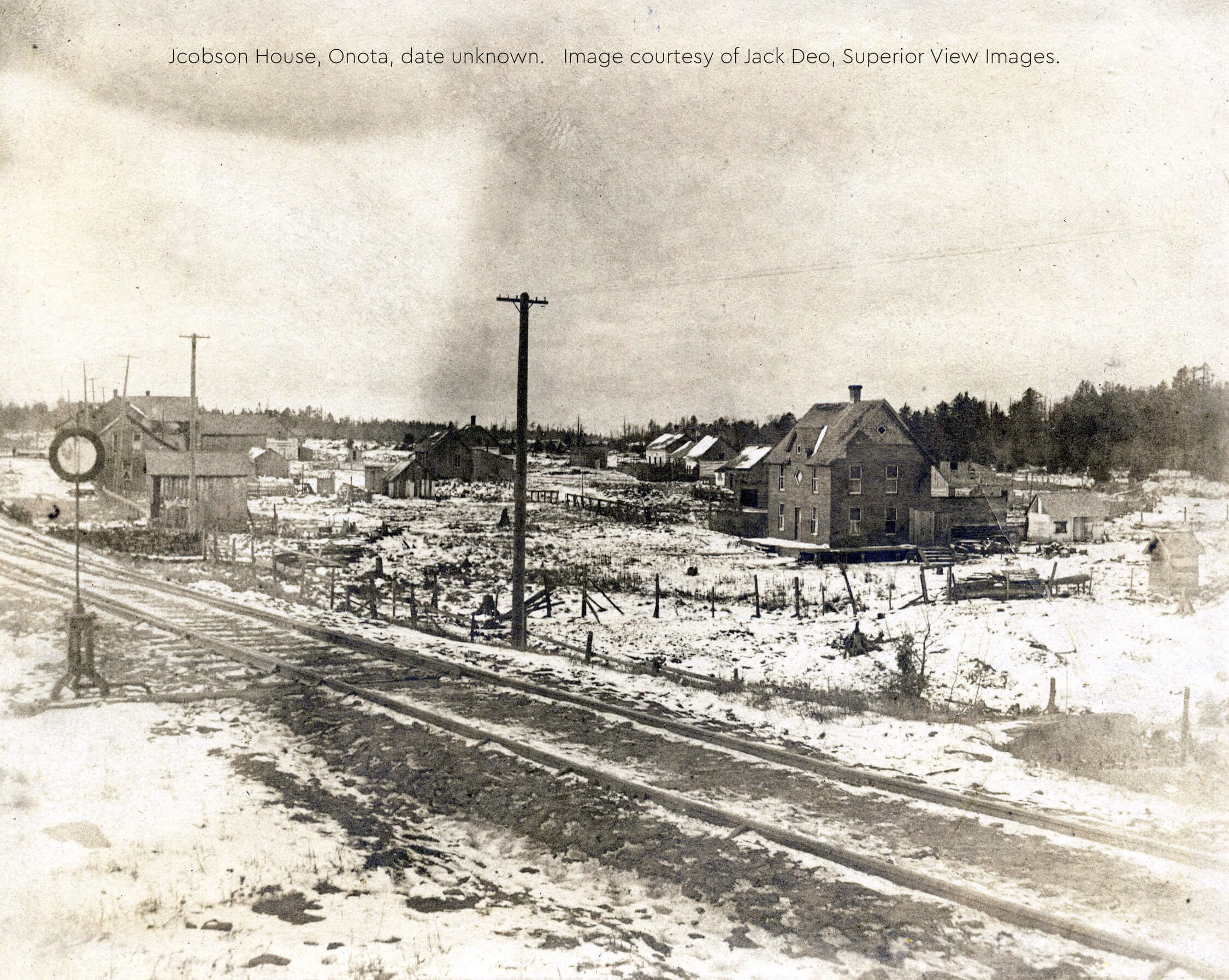 Historic Jacobson House with surrounding snow-covered landscape.