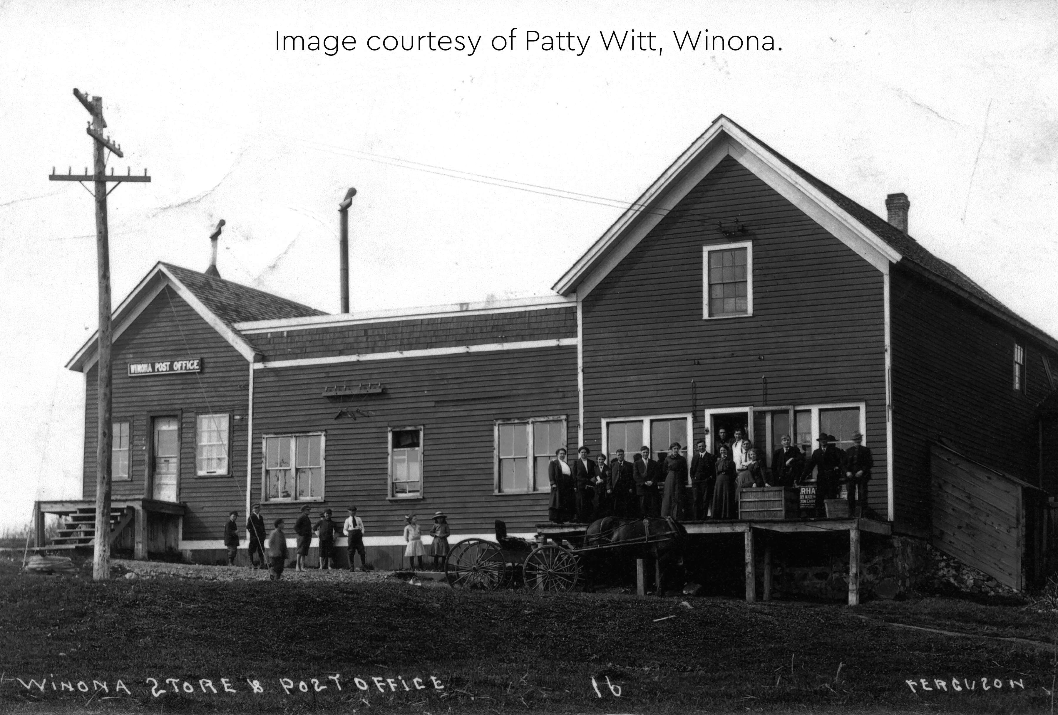 Historic photo of the Winona store and post office with a group of people gathered outside.
