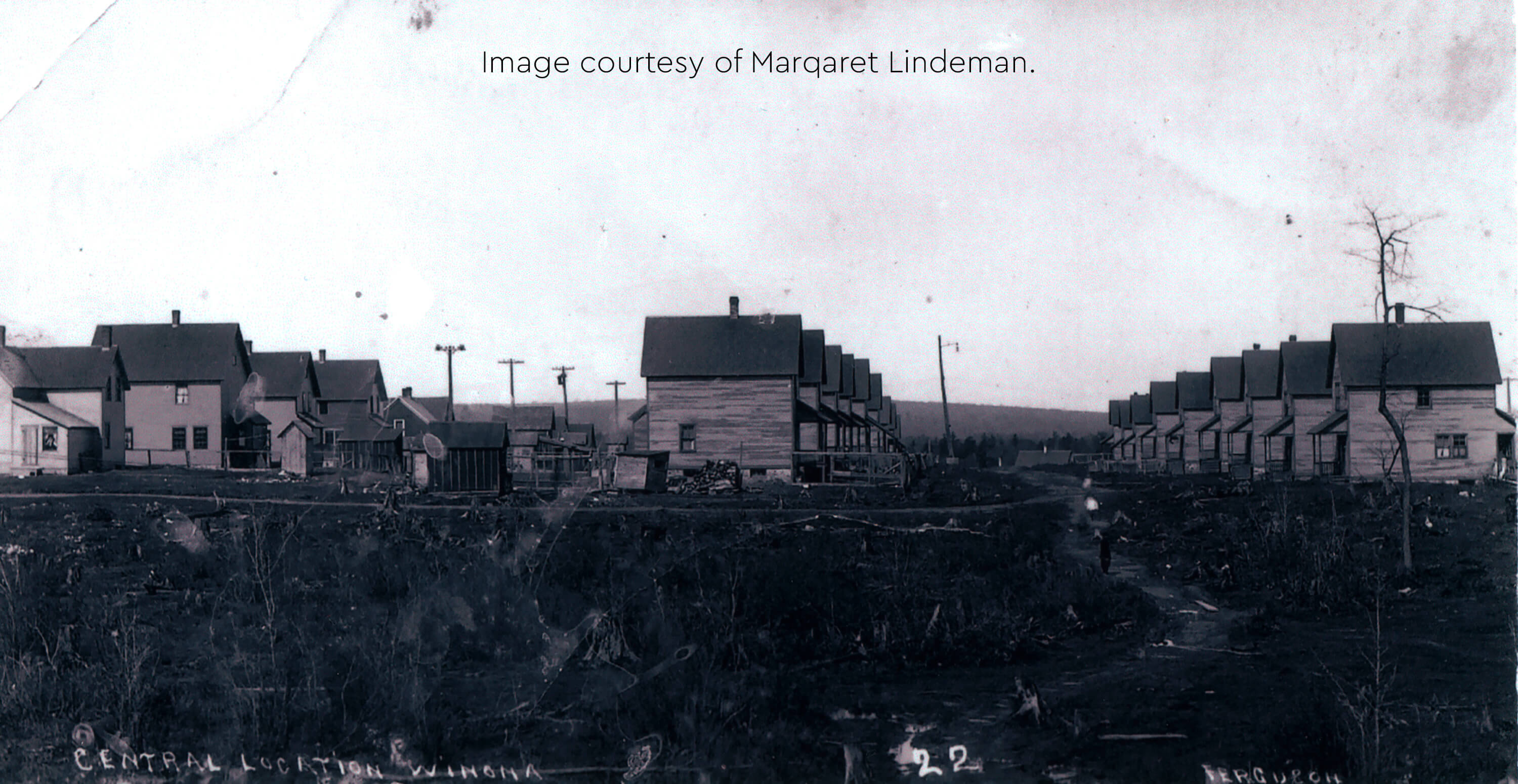 Historic photo of rows of identical company houses in Winona, Michigan.