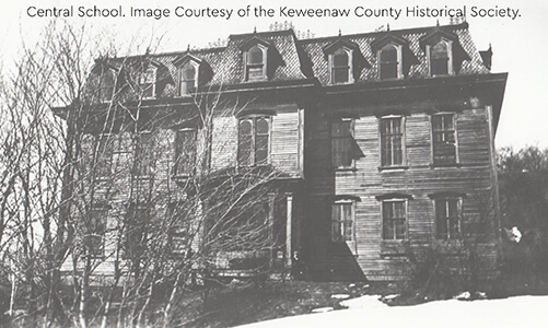 Central School, a large wooden building with a mansard roof and dormer windows.
