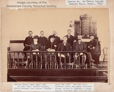 A historic photo of the Central Church choir members with a large organ behind them.