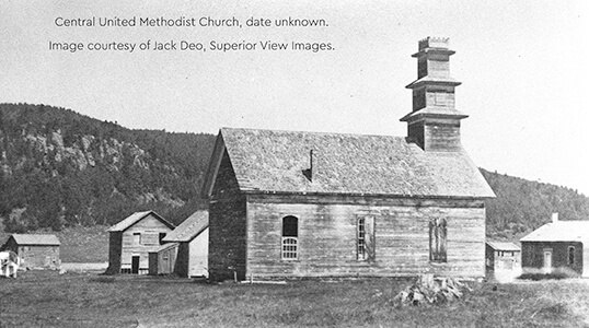 A historic image of Central United Methodist Church, a wooden building with a tiered square tower.