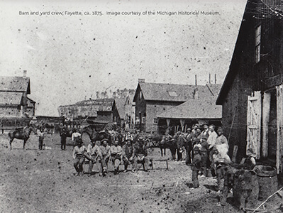 Historic photo of barn workers, horses, and buildings in Fayette, ca. 1875.