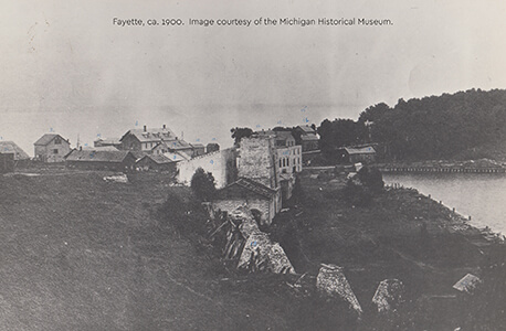 Historic view of Fayette's stone ruins, buildings, and shoreline, ca. 1900.