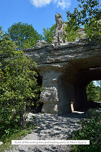 Ruins of sorting bins and loading ports with stone pillars at Fiborn Quarry.