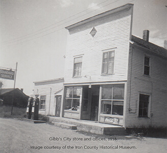 A historic photograph of a two-story wooden store.