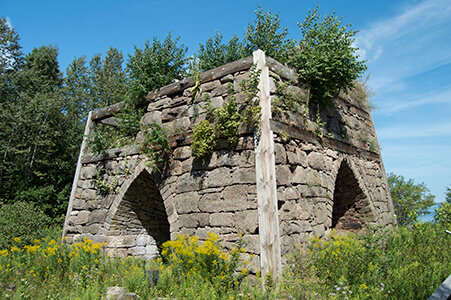 Close view of restored Bay Furnace with vegetation.