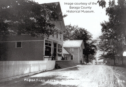 Historical image of the Pequaming Store along a dirt road
