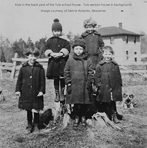 Historical photo of five children posing in the yard of the Tula schoolhouse, 1920s.