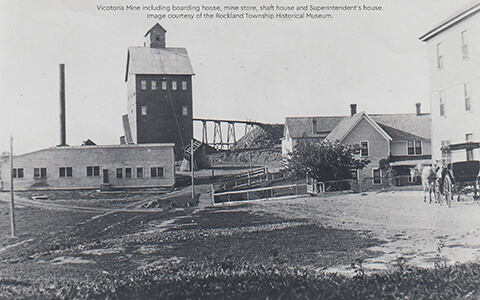 Black and white photo of Victoria Mine, showing mine buildings and horse-drawn wagon.