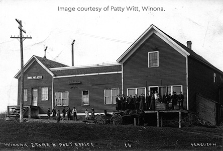 Historic photo of the Winona store and post office with a group of people gathered outside.