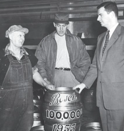 Phil Ruppe and two other employees show off Bosch’s 100,000th keg of beer.