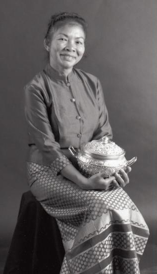 Aoy LaChapelle holding a decorated serving pot.